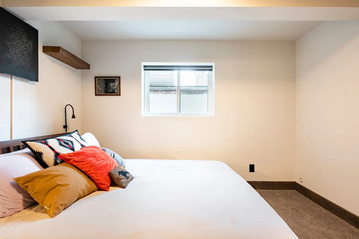 The garden-level bedroom in warm light