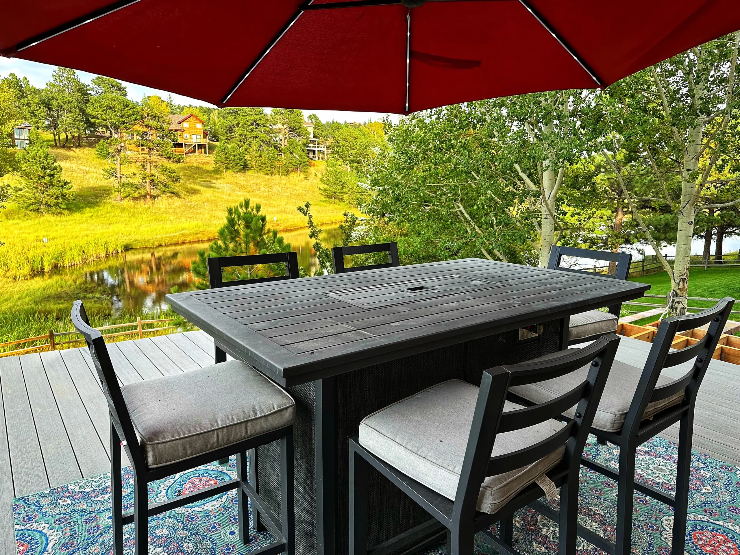 Patio dining under the umbrella, meadow beyond
